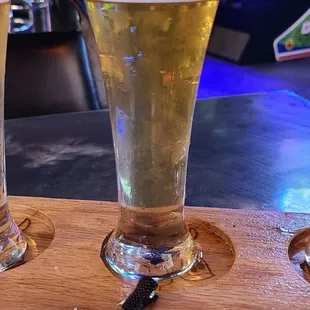 three glasses of beer on a wooden tray