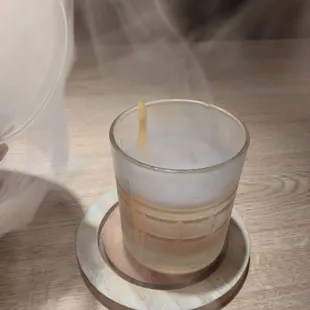 Lifting the dome off a smoked old fashion, ($12).