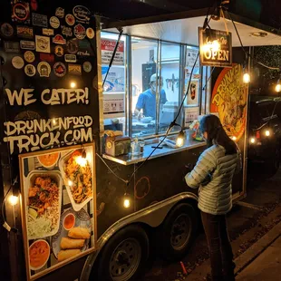 Outside the Drunken Noodles Food Truck (trailer hauled by pickup truck). Passenger side and ordering window.