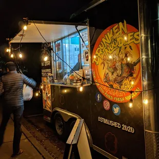 Outside the Drunken Noodles Food Truck (trailer hauled by pickup truck). Passenger side and ordering window.