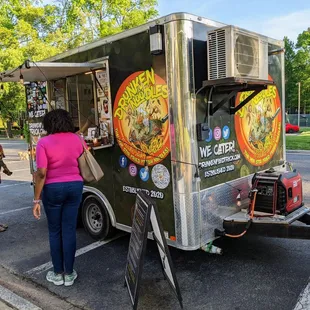 Outside the food truck, passenger side. Ordering window.