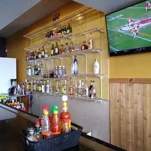 TV&apos;s on for the games., Bar ready to pour your favorite drink