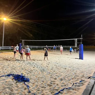 eople playing volleyball on the beach