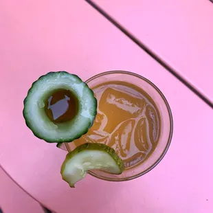 a cucumber on a pink table
