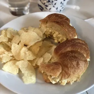 a croissant sandwich and chips