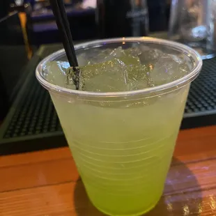 a green drink in a plastic cup