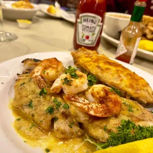 Redfish over fried eggplant topped with shrimp . Stuffed potato.