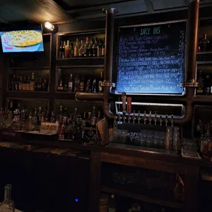 a bar with a chalkboard on the wall