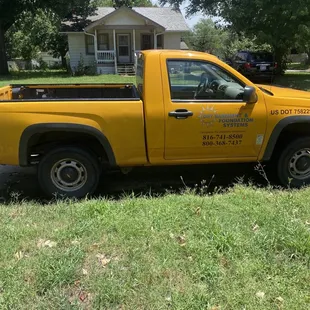 a yellow truck parked on the side of the road
