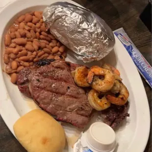 Ribeye Cajun shrimp baked potato and red beans