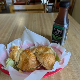 Tuna sandwich on a croissant with iced tea