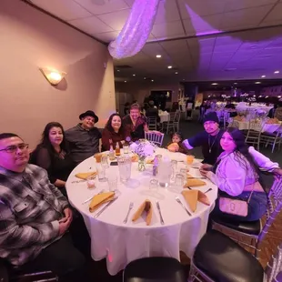 a group of people sitting around a table