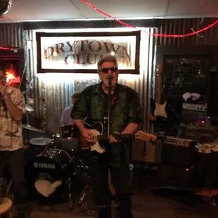 two men playing guitar and singing