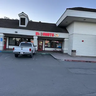 a truck parked in front of a store