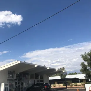 View of D&apos;s Market and of parking lot outside it.