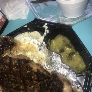 Steak with a delicious sauce, garlic mash, yams, and mixed cabbage and greens