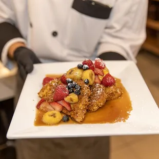 a person holding a plate of food