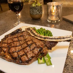 a steak and broccoli on a white plate
