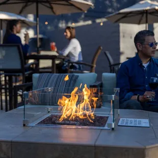 a man sitting at a fire pit