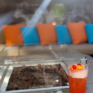 a drink and a magazine on a table