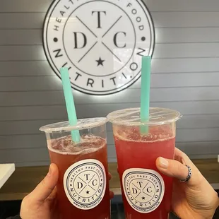 two people holding drinks in their hands