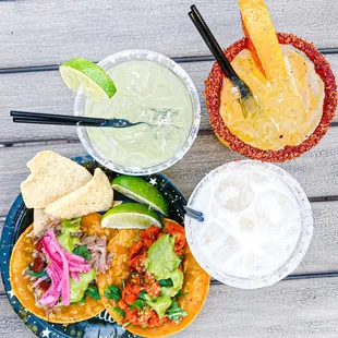 a plate of tacos and a drink