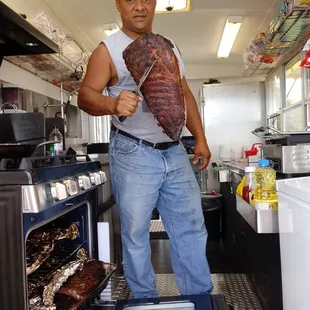 a man holding a large piece of meat