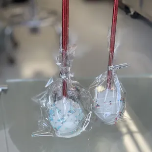 two cake pops wrapped in plastic