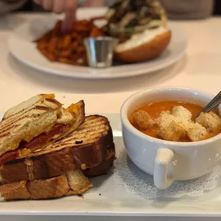 a plate with a sandwich and a bowl of soup
