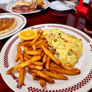 Veggie omelet with fries.