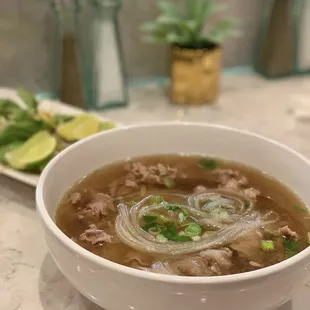 a bowl of soup and a plate of vegetables