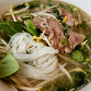 a bowl of soup with meat and noodles