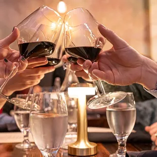 a group of people toasting with wine glasses