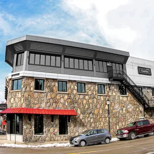 a stone building with a red awning
