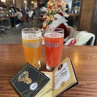 two glasses of beer and a book