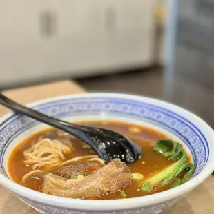 a bowl of soup with noodles and meat
