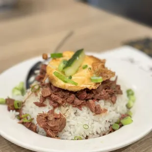 a plate of rice and beef