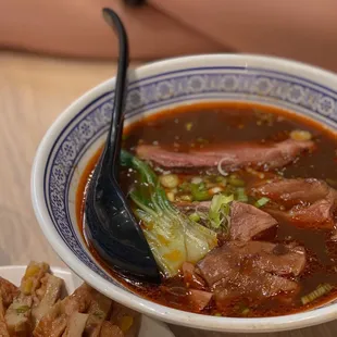 a bowl of soup with meat and vegetables