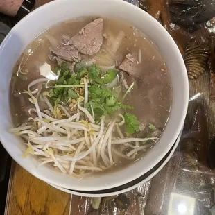 Spicy soup with beef, topped with chopped peanuts