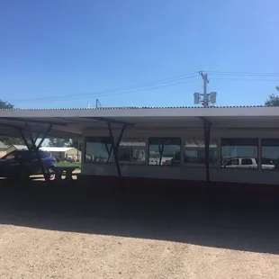 a man sitting on a bench in front of a bus