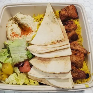 Chicken Kabob Plate with rice, hummus and salad.