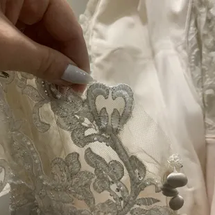 appliqué attached to the back of the mesh (supposed to be-low back) unable to be removed- thus altering the integrity of the gown