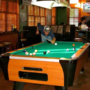 a man playing pool in a pub