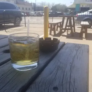 a glass of beer on a picnic table