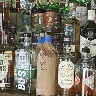bottles of alcohol on a bar shelf