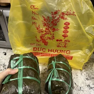 two wrapped food items on a counter