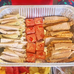 a tray of sandwiches and fruit