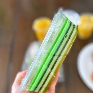 a person holding a package of sliced cucumbers