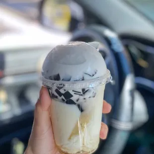 a hand holding a cup of ice cream