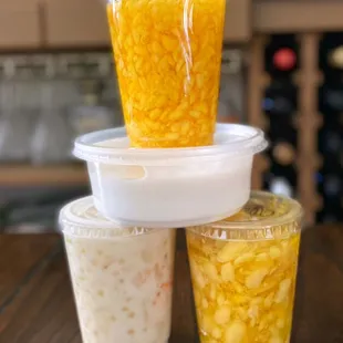 a stack of three plastic containers filled with food